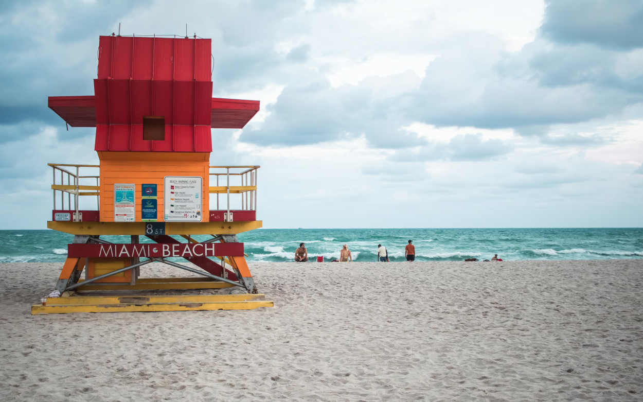 Iconic lifeguard tower overlooking the sandy shores of South Beach Miami.
